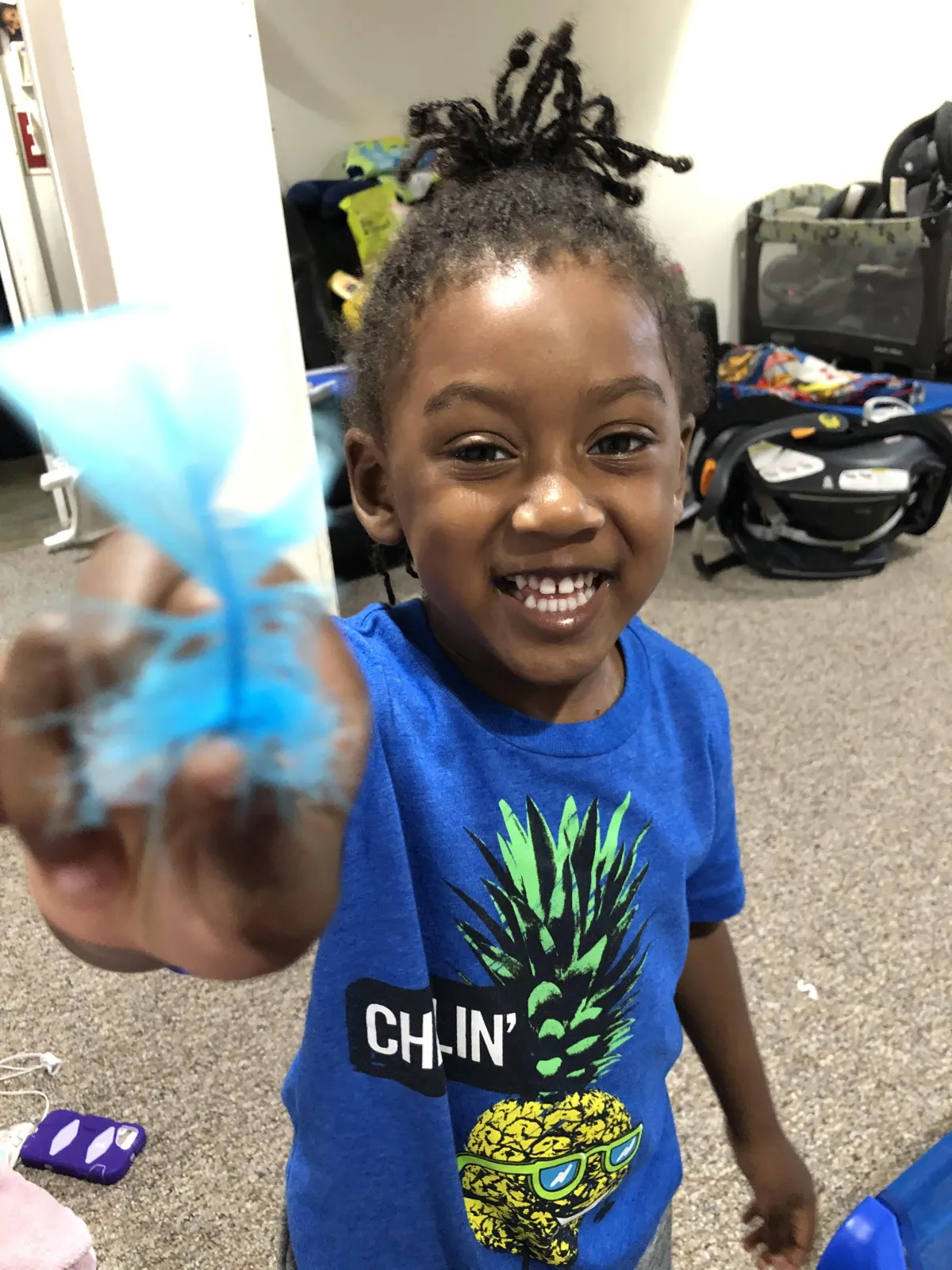 Boy picks paper out of different colored liquids