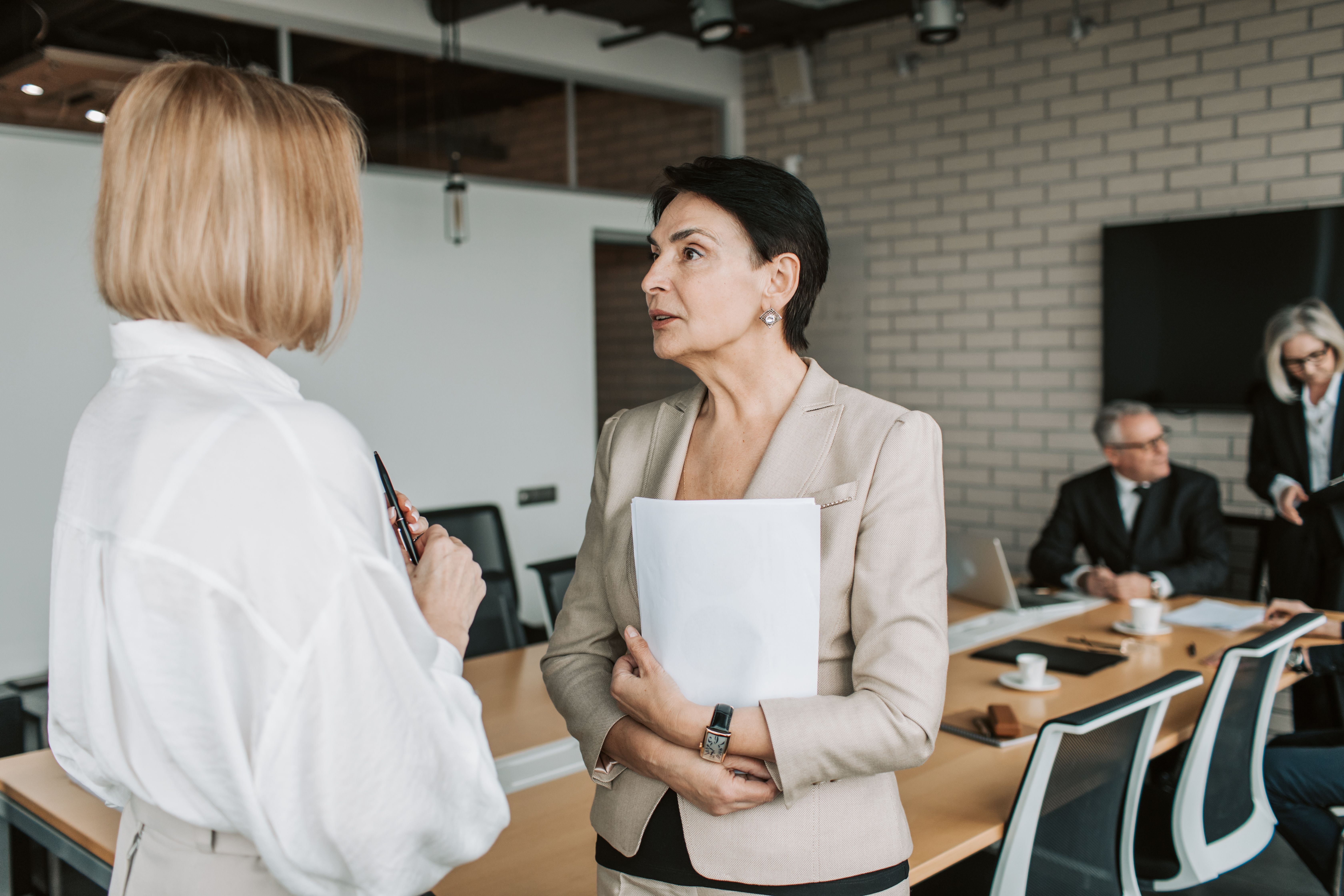 Two colleagues discussing a workplace matter in an office