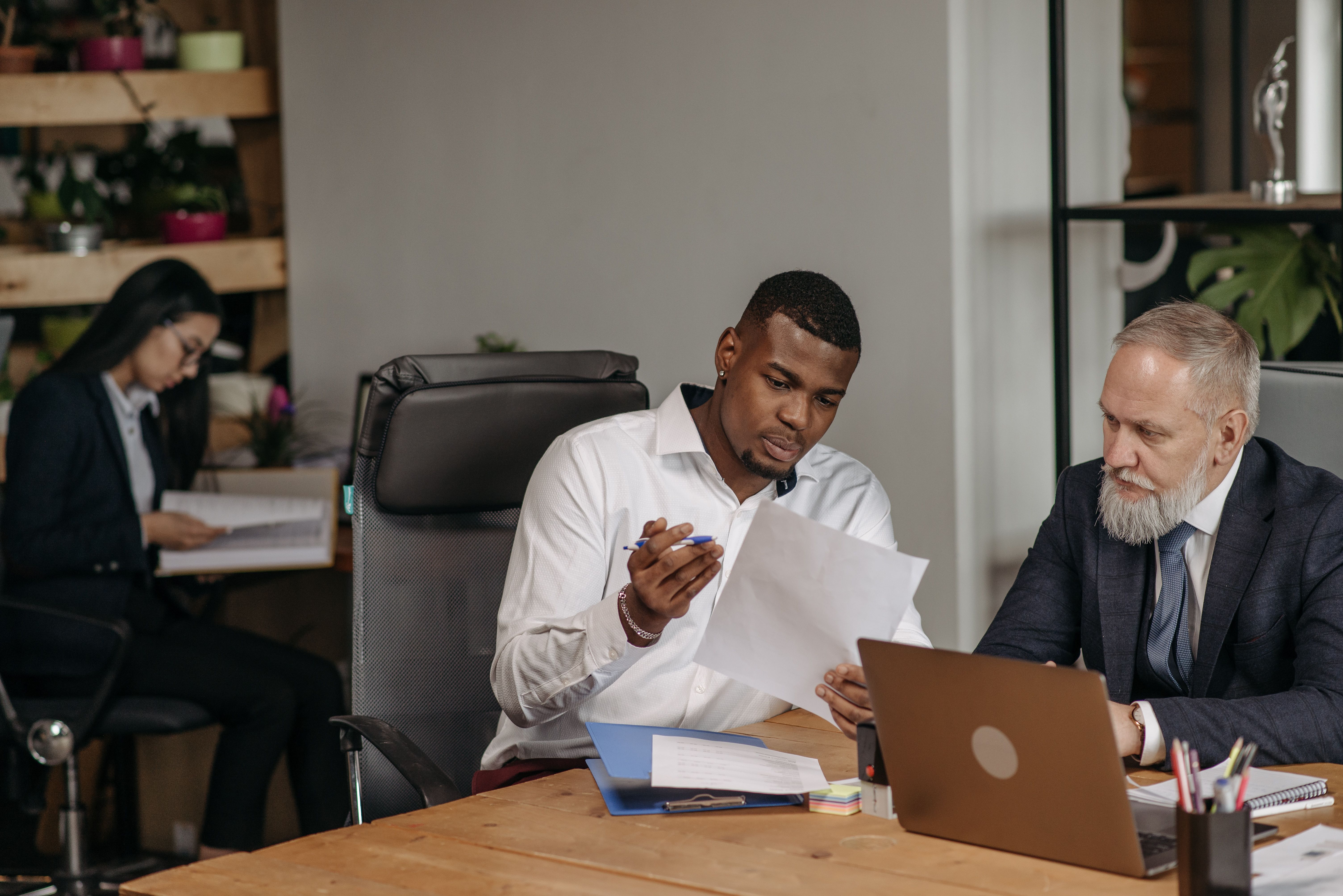 Manager and employee reviewing documents together at a desk