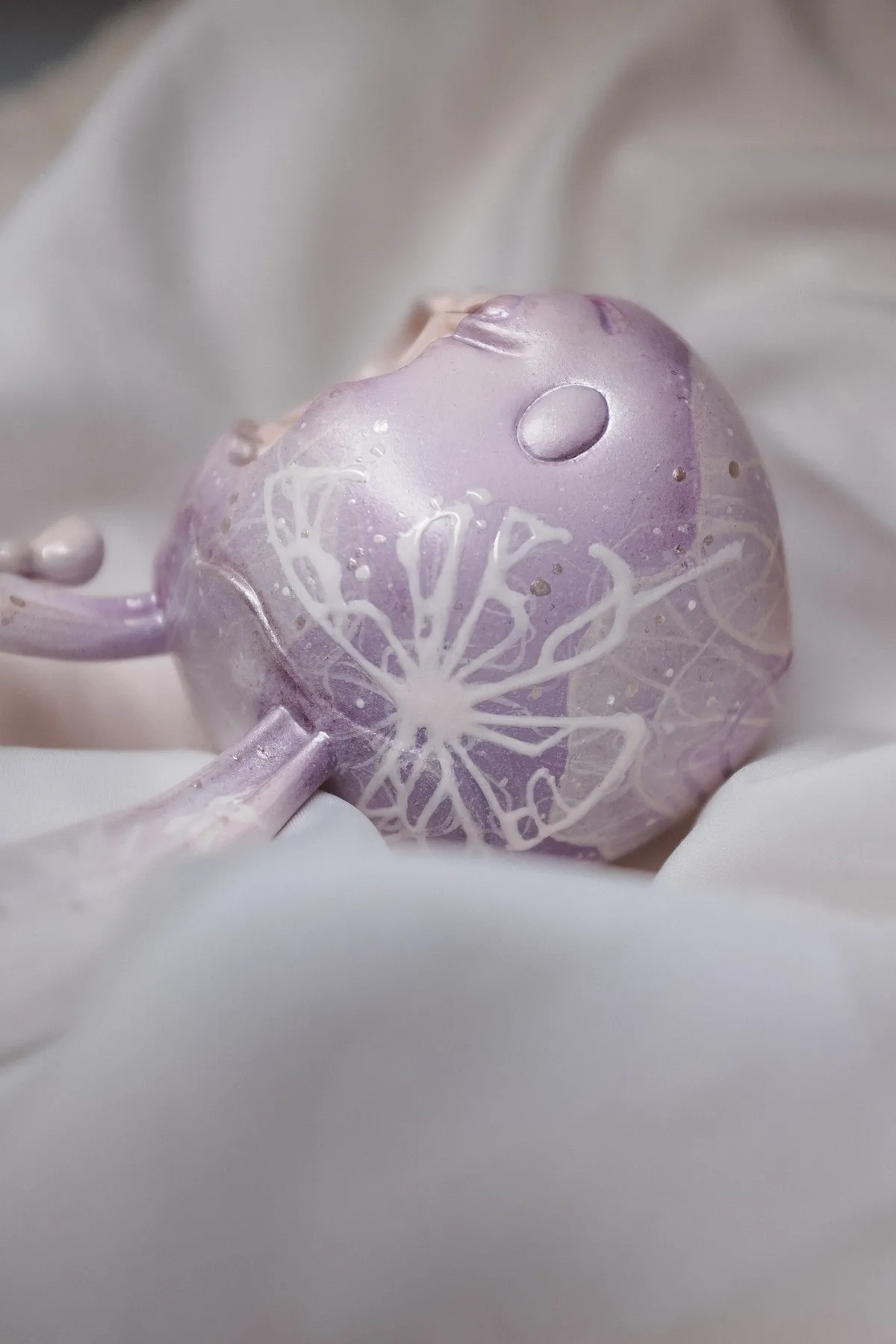 Butterfly, a custom Goodbunny skull in lavender with a white butterfly painted across it