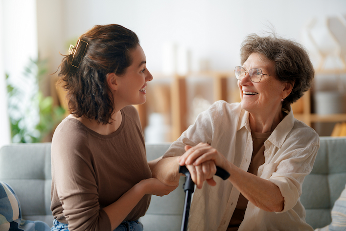 Professional and older adult talking together in a supportive setting, representing how BRIDGES for Older Adults connects caregivers and communities to improve behavioral health and healthy aging.