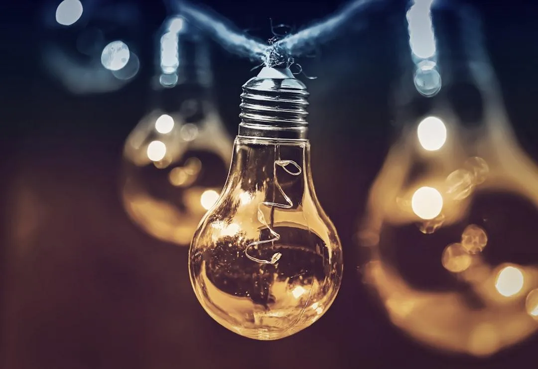 Close-up of a glowing light bulb symbolizing innovative AI communication solutions for businesses.