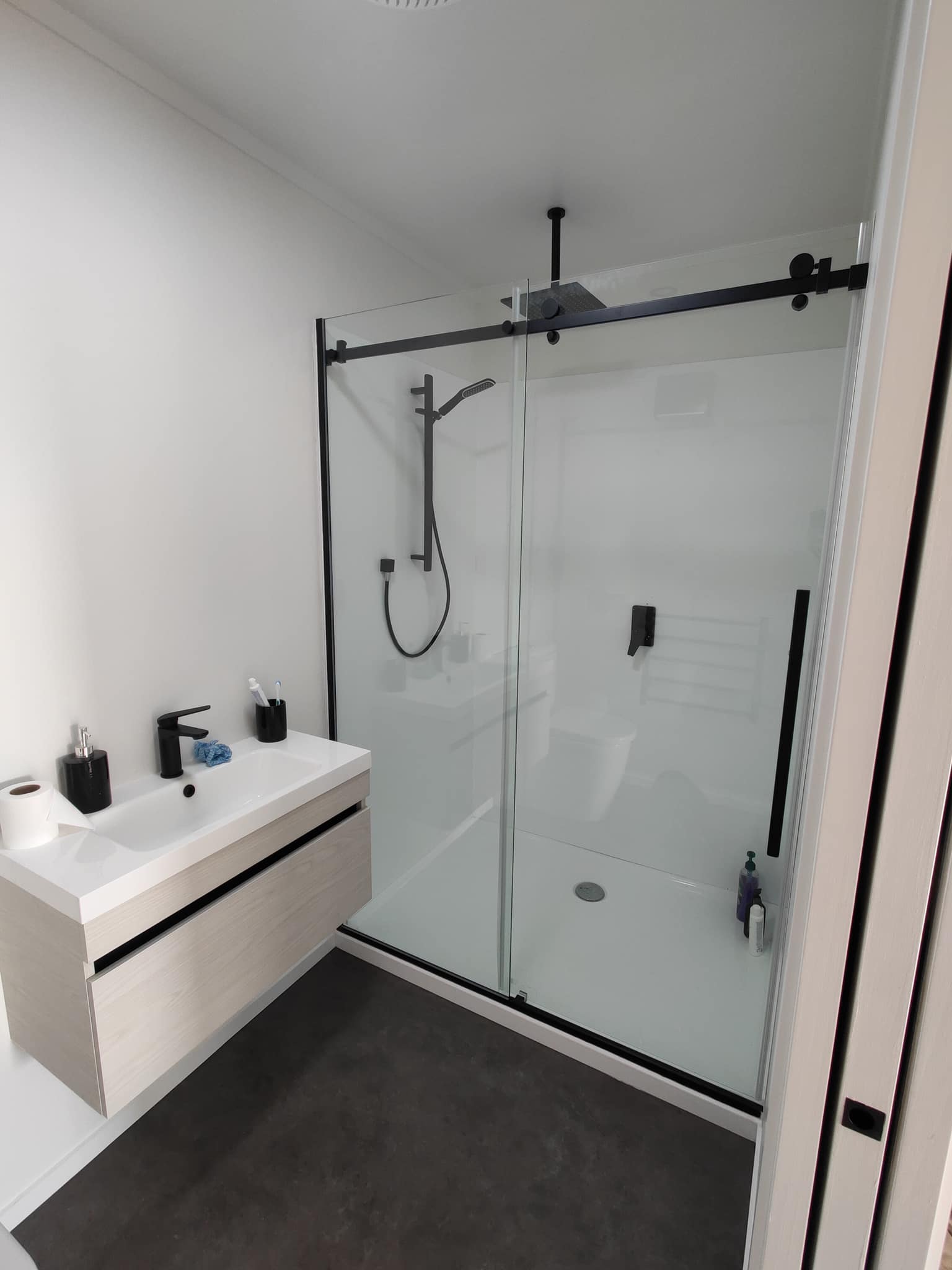 Modern bathroom renovation in Gore with walk in shower and black fittings
