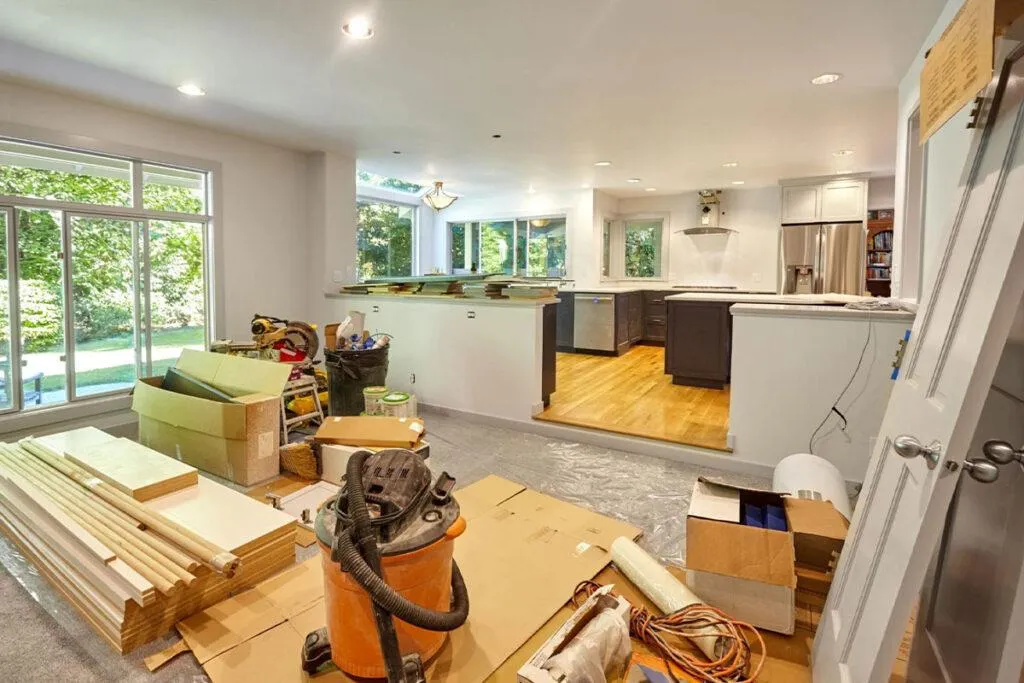 A kitchen with a spacious wooden table and a large window