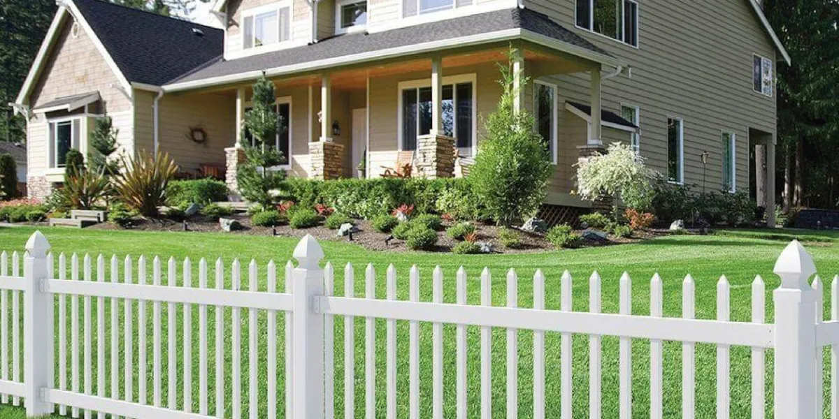 Traditional white picket fence framing a charming house