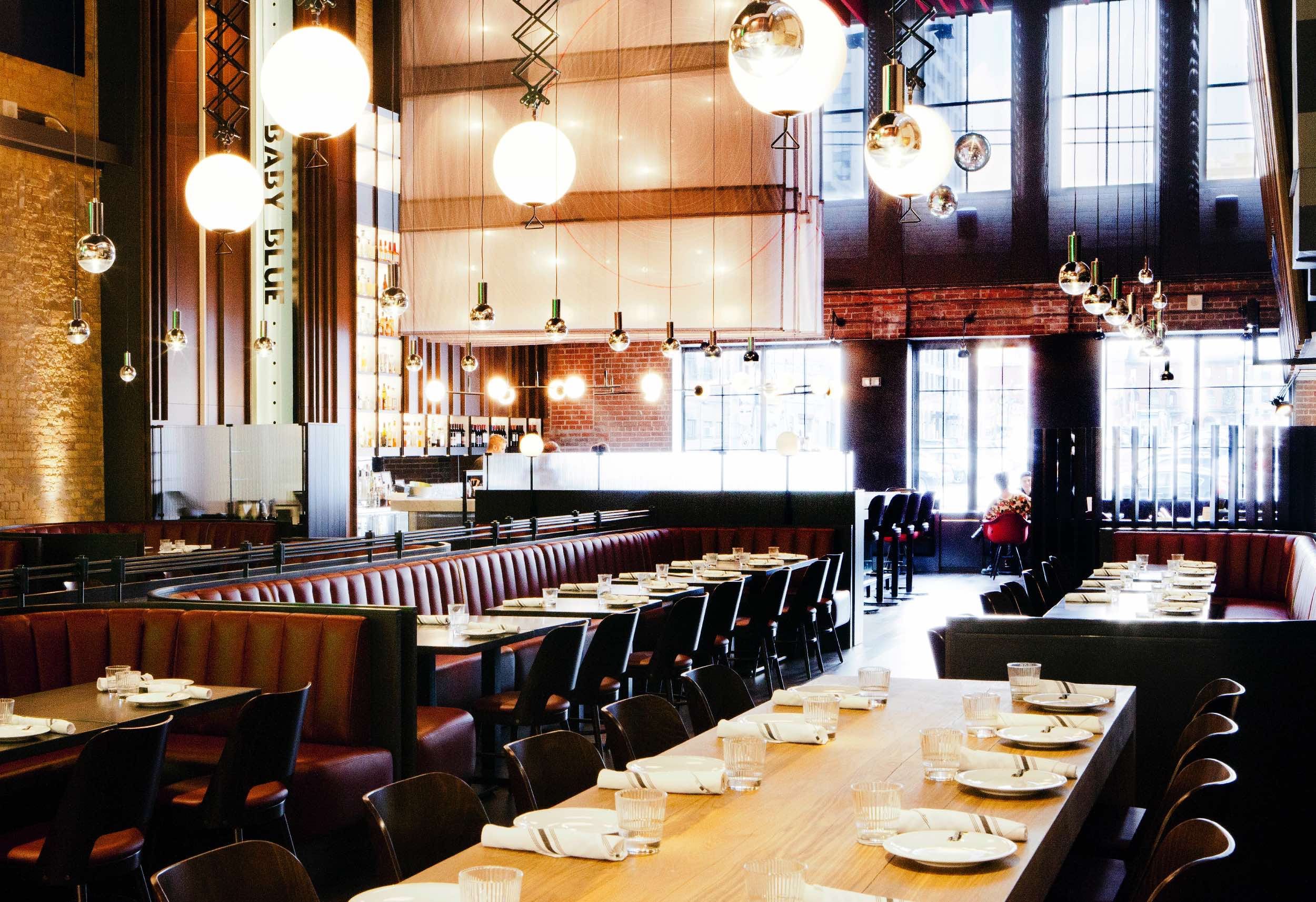 Guests enjoying dinner at The Carbon Bar in a warm, elegant BBQ setting