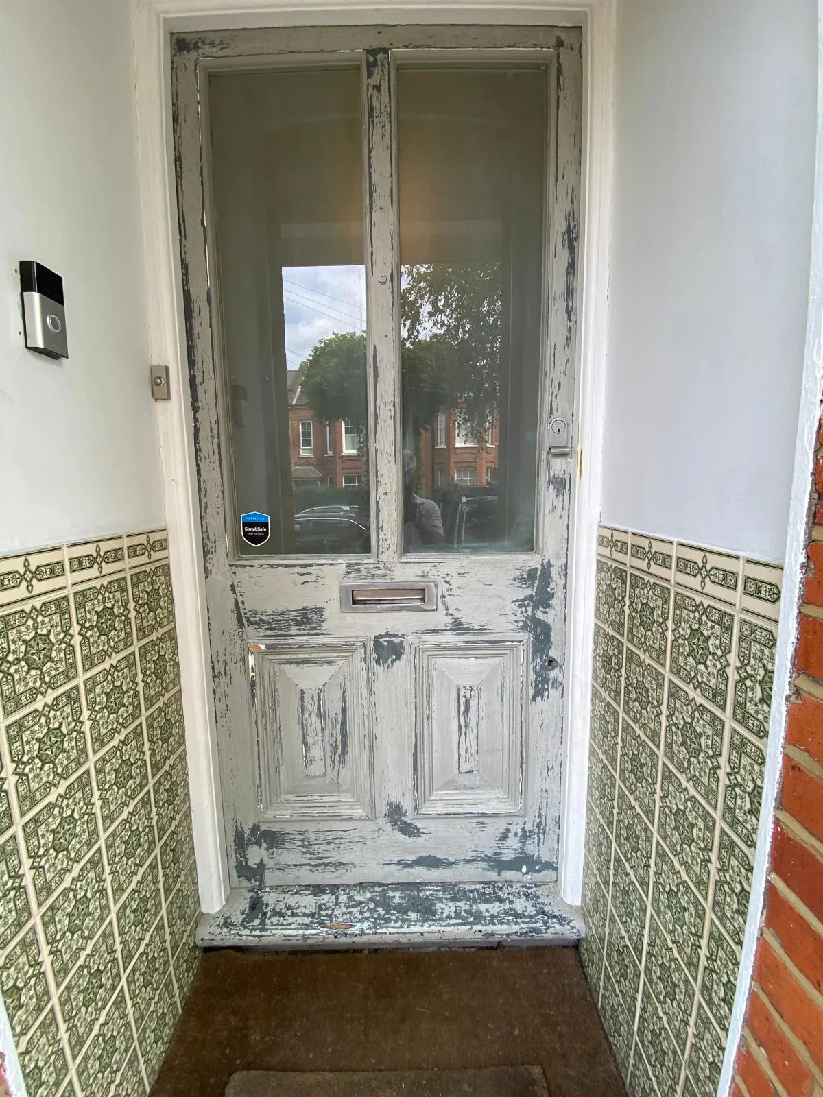 A weathered and peeling Victorian timber front door in Epsom, showing severe paint flaking before professional restoration.