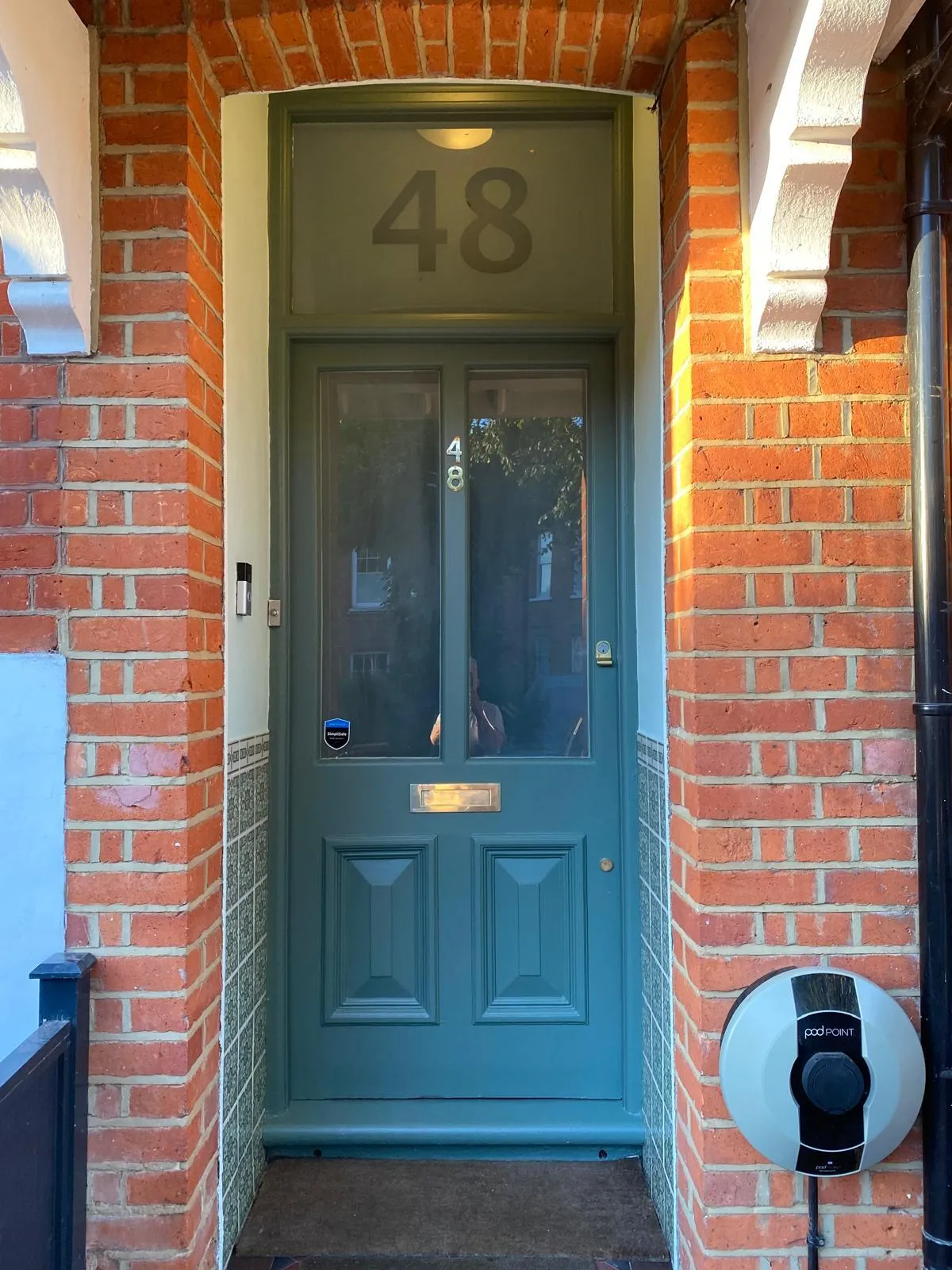 The finished front door restoration in Epsom, featuring a sharp deep green finish and restored curb appeal for a Victorian home.