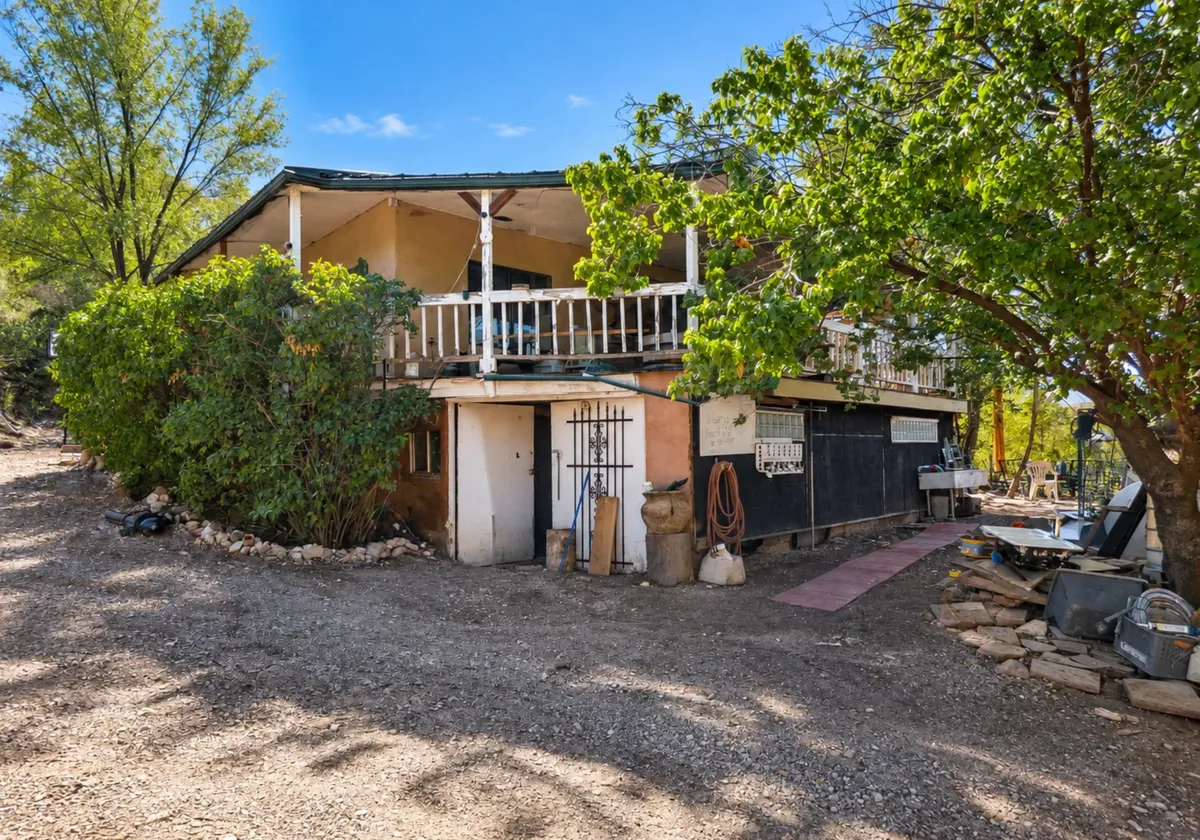 Exterior of 6 Sedillo Road with a wraparound porch on 1.72 acres in Tijeras, New Mexico
