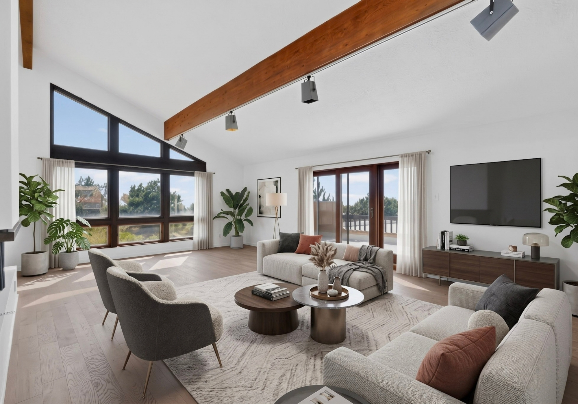 Staged living room at 450 Live Oak Lane with floor-to-ceiling windows, exposed beams, fireplace, and Sandia Heights views