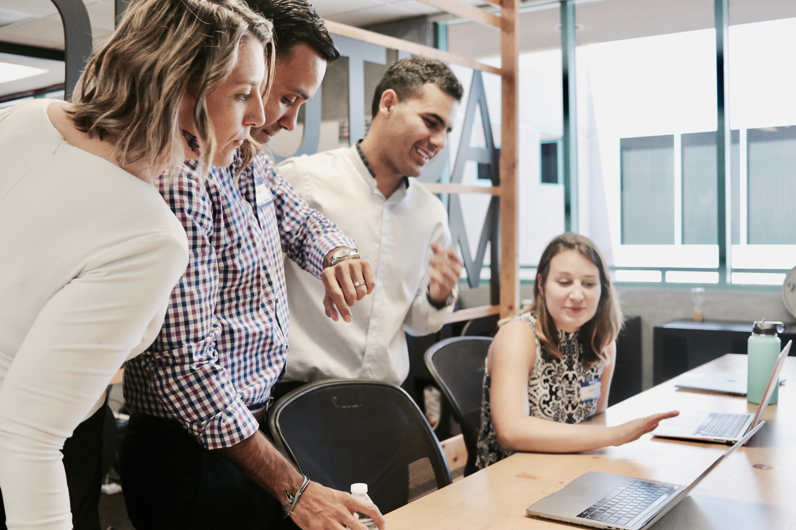 UK business owner reviewing loan papers with a financial advisor in a bright office