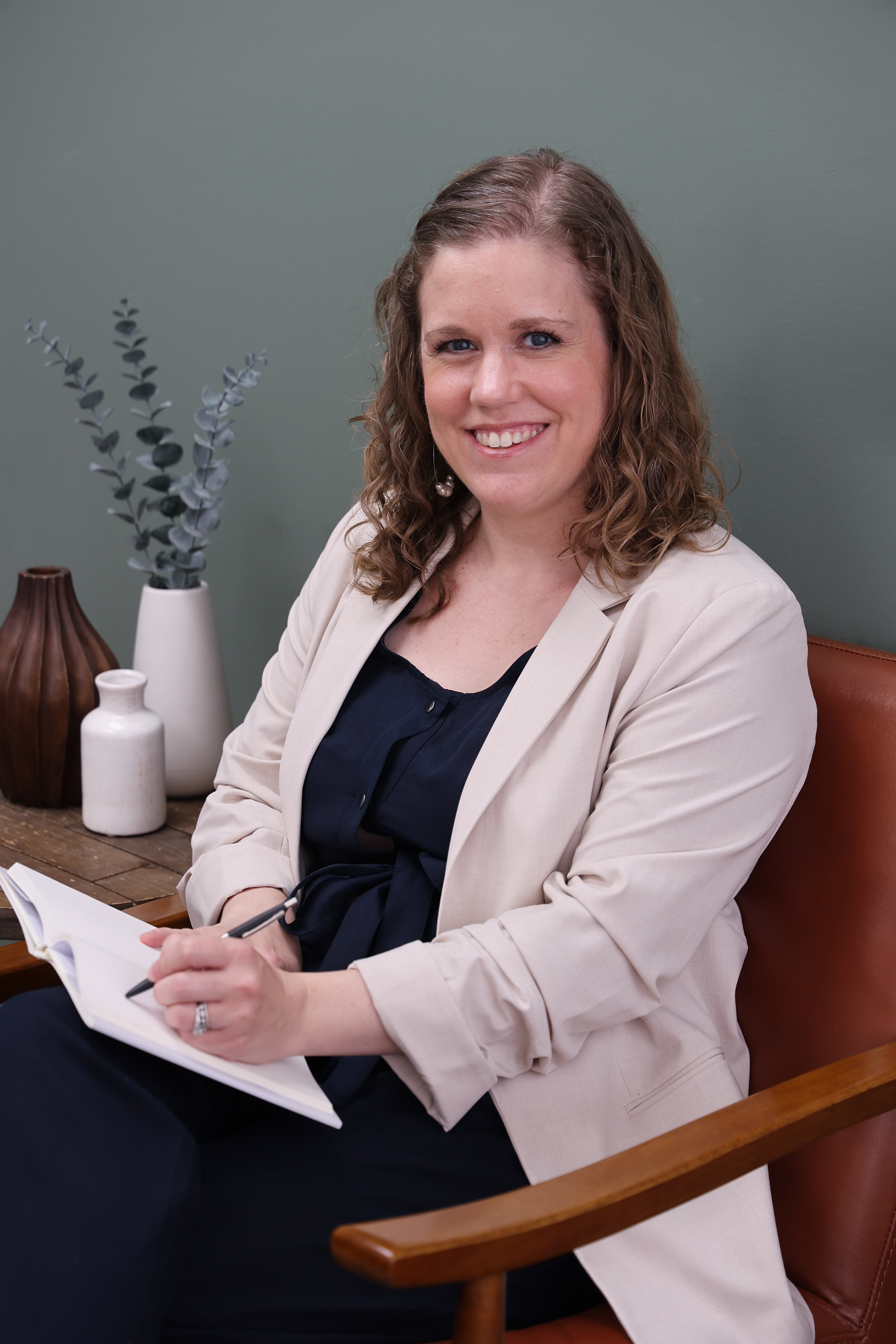 Dr. Emily Altunay in clinic taking therapy session notes