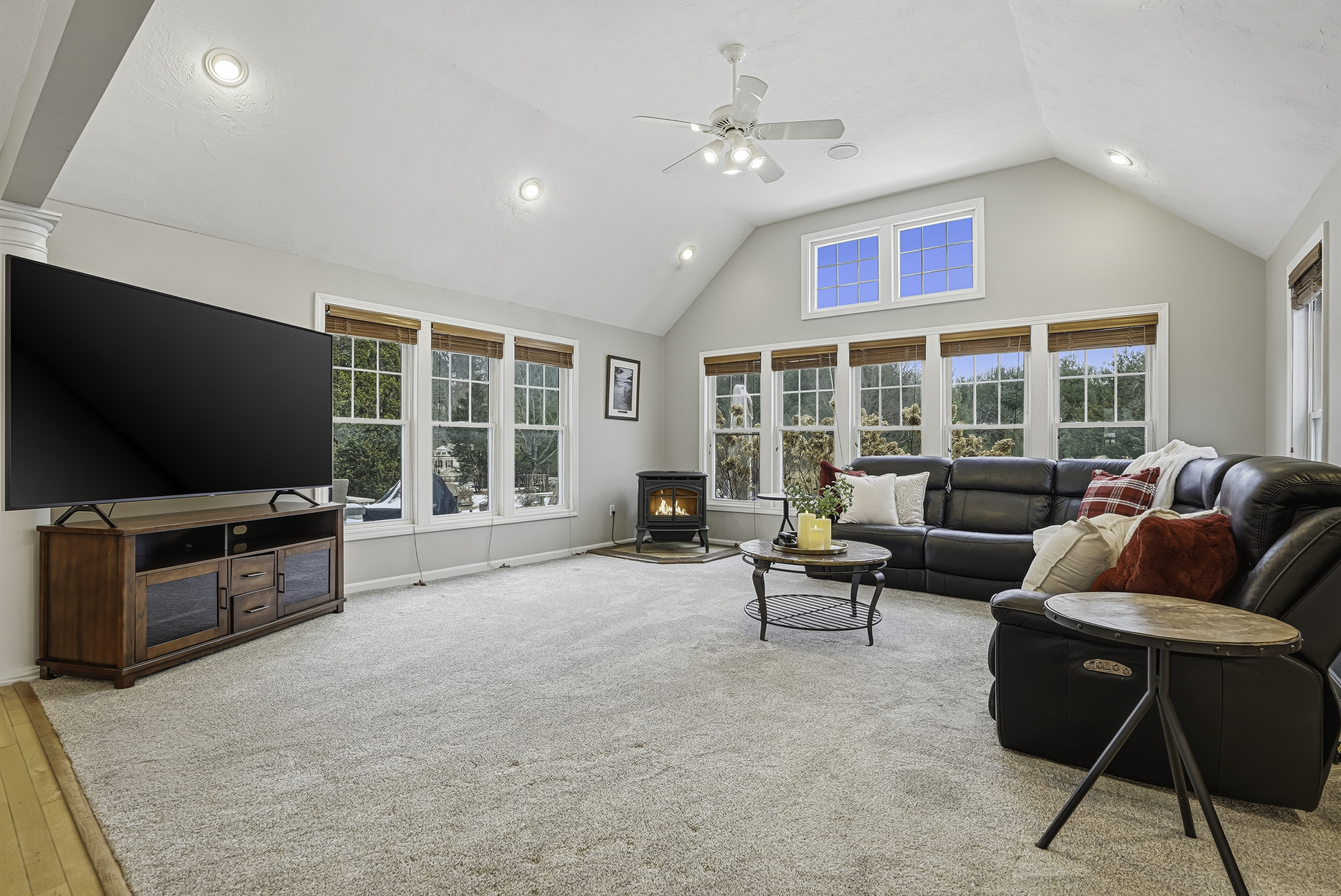 a dining room with a long table and lots of windows