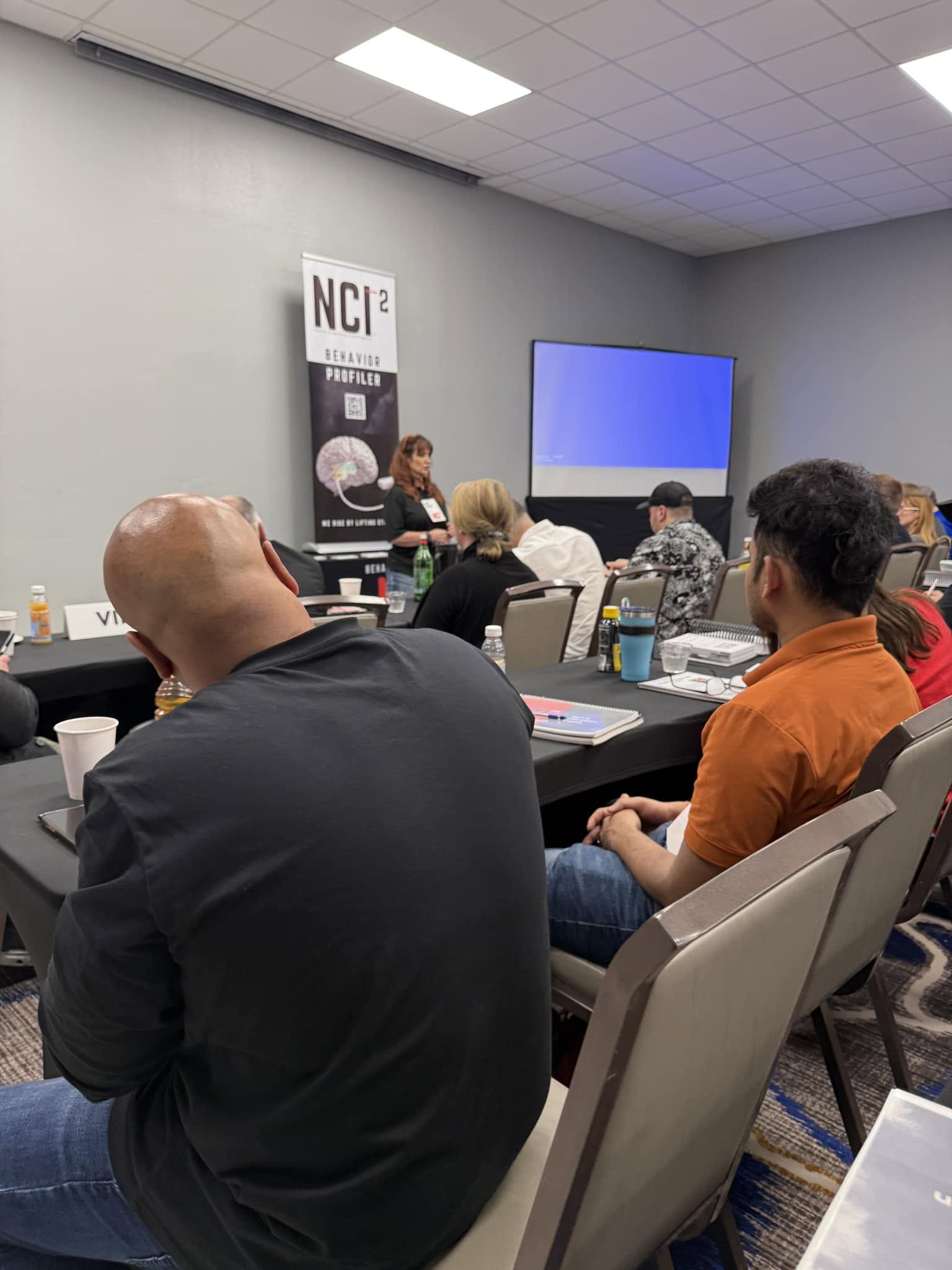 Amy Jo Honey leading an intimate corporate sales training session in a boardroom