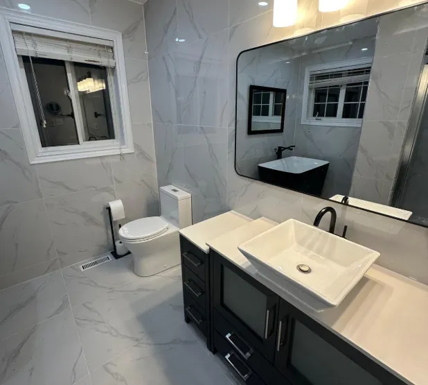 Bathroom remodeling service with updated tile, vanity, fixtures, and modern finishes