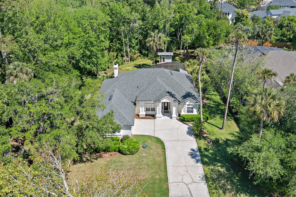  Front exterior of 108 Natures Way in St. Johns Plantation, Ponte Vedra Beach, a single-story pool home on a .78-acre tree-canopied lot with a detached office.