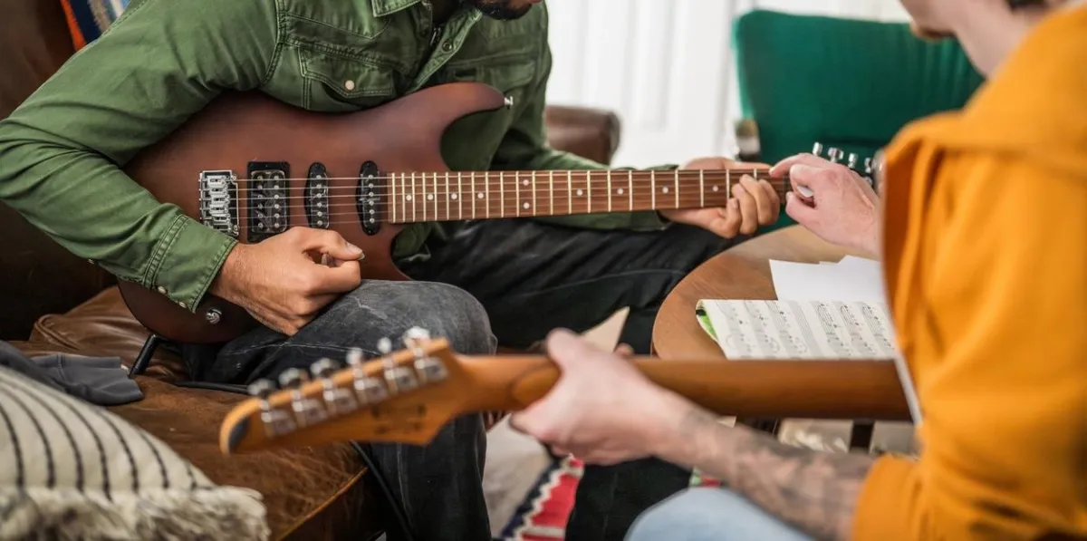 shallow focus photography of brown acoustic guitar