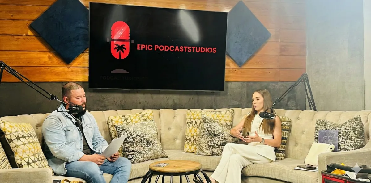 Press clip thumbnail of camera operator adjusting lens with cinematic bokeh lights.