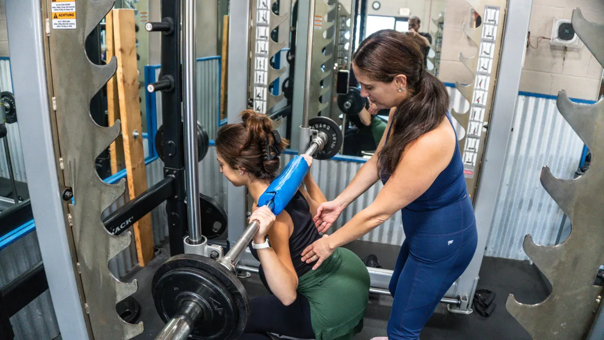Strength training coach working one-on-one with a client at Fuel Your Training in Northbrook, IL