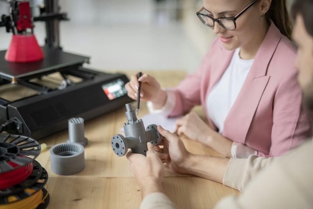 Two technical people working on a mechanical prototype