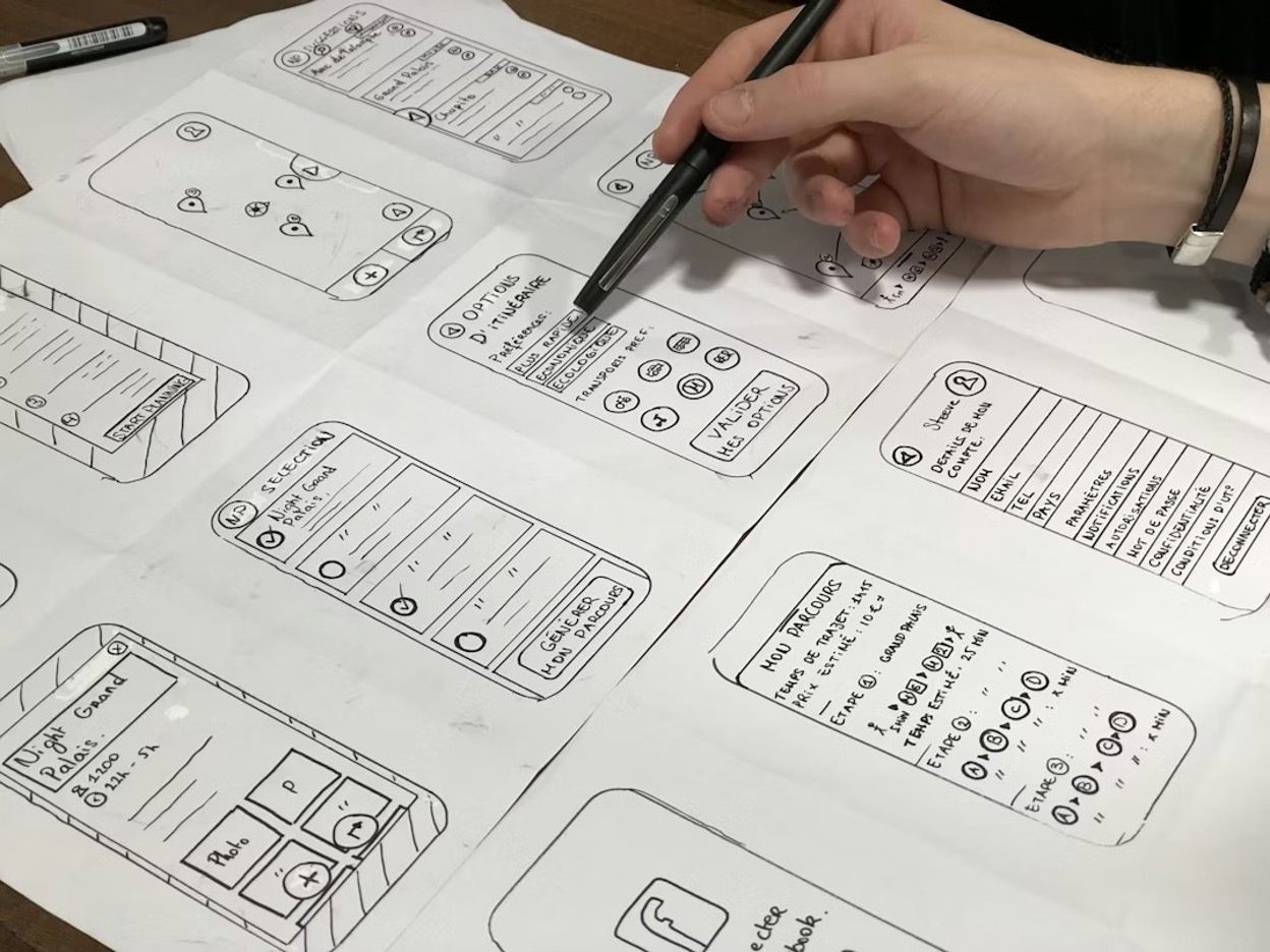 person working on a product prototype using white sketch paper and a pencil