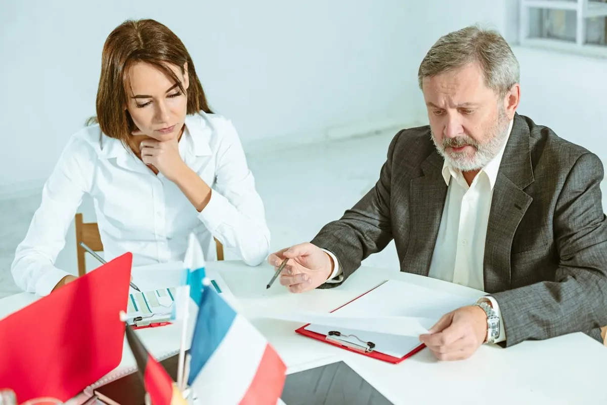 A woman speaking to a lawyer in his office