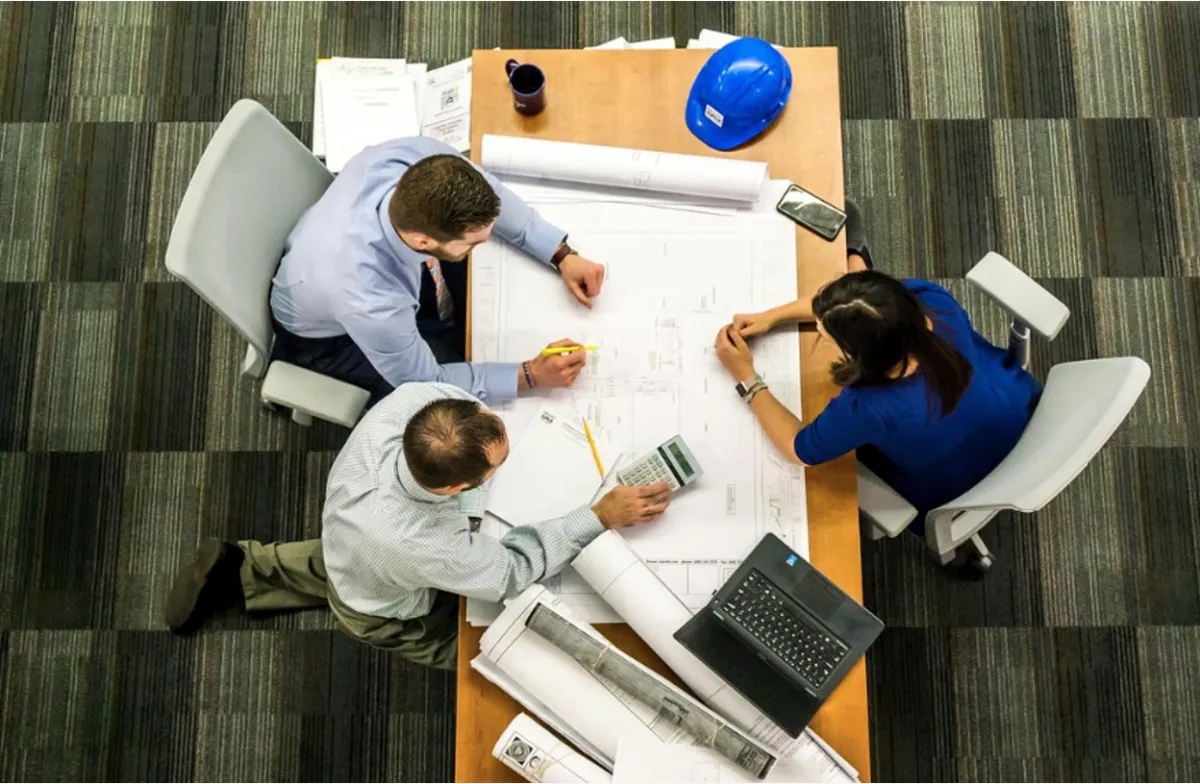 A group of inventors comparing the protections offered by patents, copyrights, and trademarks