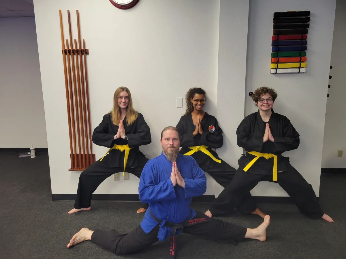 4 adults posing in a horse stance at omega martial arts in plano