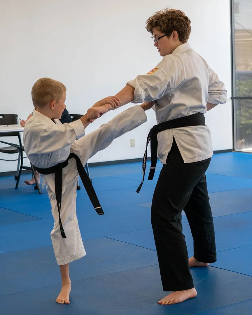 Two students giving a self-defense demonstration at Omega Martial Arts in Plano