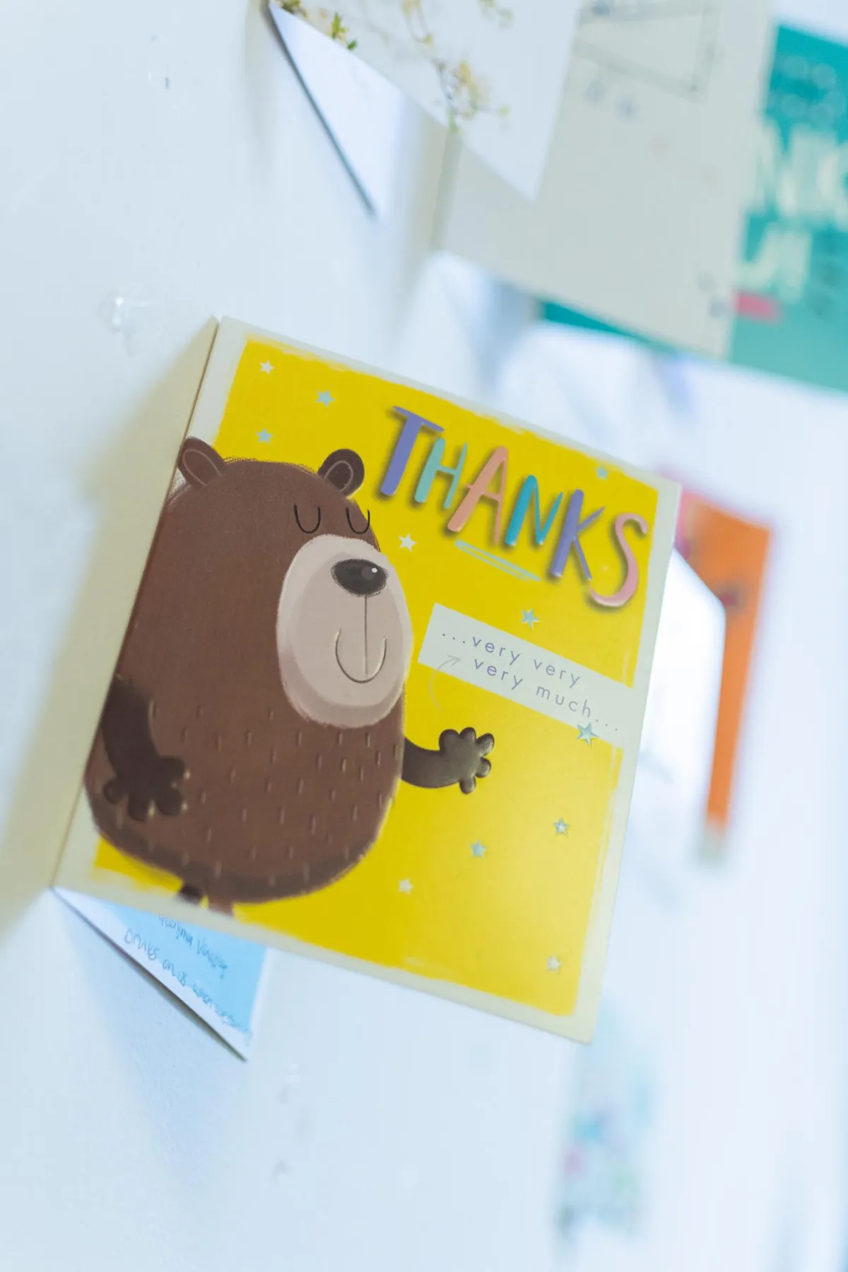 Thank you card with a cartoon bear displayed on an office wall, showing appreciation from a happy mortgage client.