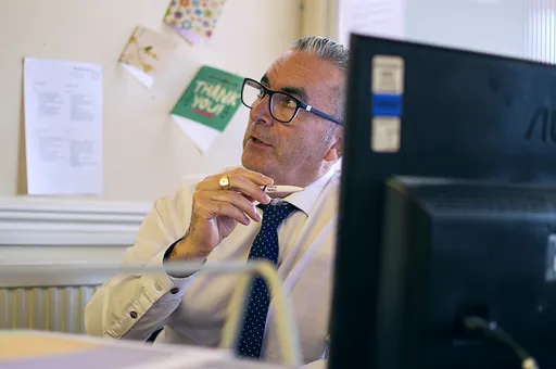 Experienced advisor at Aspect Mortgages working at his desk, focused on providing expert, independent mortgage advice.
