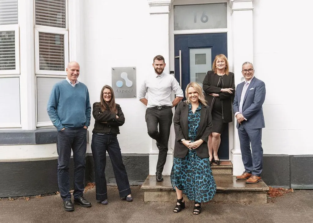 the aspect mortgages team standing in front of their office