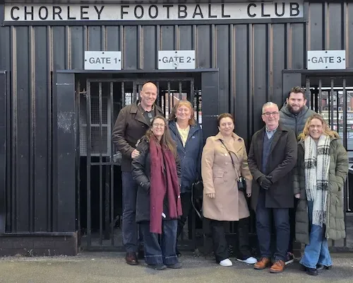 The Aspect Mortgages team outside the turnstiles at Victory Park, Chorley Football Club