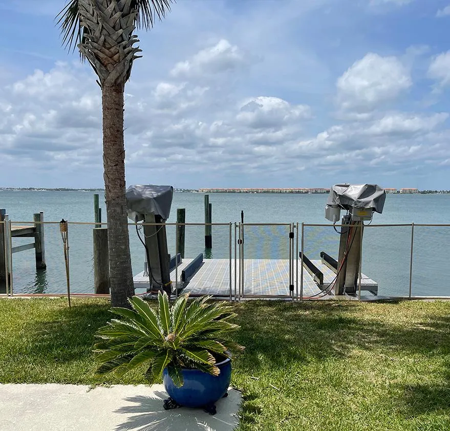barrier and residential seawall protecting a private dock on the Treasure Coast, Florida, with palm tree and ocean view. Protect your waterfront property with durable residential seawalls. Custom seawall installation by Baby Guard for homes on Florida's Treasure Coast. residential seawall installation, seawall contractors Treasure Coast, Florida seawall repair, protect waterfront property, erosion control solutions, seawall for private dock, backyard seawall barrier, custom seawall Florida, seawall near me, coastal property protection, baby guard seawalls, dock protection solutions, durable seawalls, long-lasting seawall design, Florida seawall experts, waterfront safety fencing, hurricane-resistant seawalls, shoreline erosion fix, residential marine construction, Treasure Coast seawall company, backyard ocean view barrier, glass seawall fencing, clear dock fencing, dock fencing Florida, storm surge protection, water barrier construction, seawall builders Florida, seawall company near me, protect home from erosion, residential dock safety, pool fence alternatives, coastal seawall solutions, marine-grade fencing, backyard water view safety, best seawall installers, top-rated seawall services, affordable seawalls Florida, seawall and dock repair, fence for seawalls, Florida dock protection, hurricane seawall options, seawall maintenance Florida, child-safe seawall barrier, dock fencing installation, custom fence for dock, marine barrier fencing, glass dock fence installation, dockside safety fencing, coastal home erosion protection