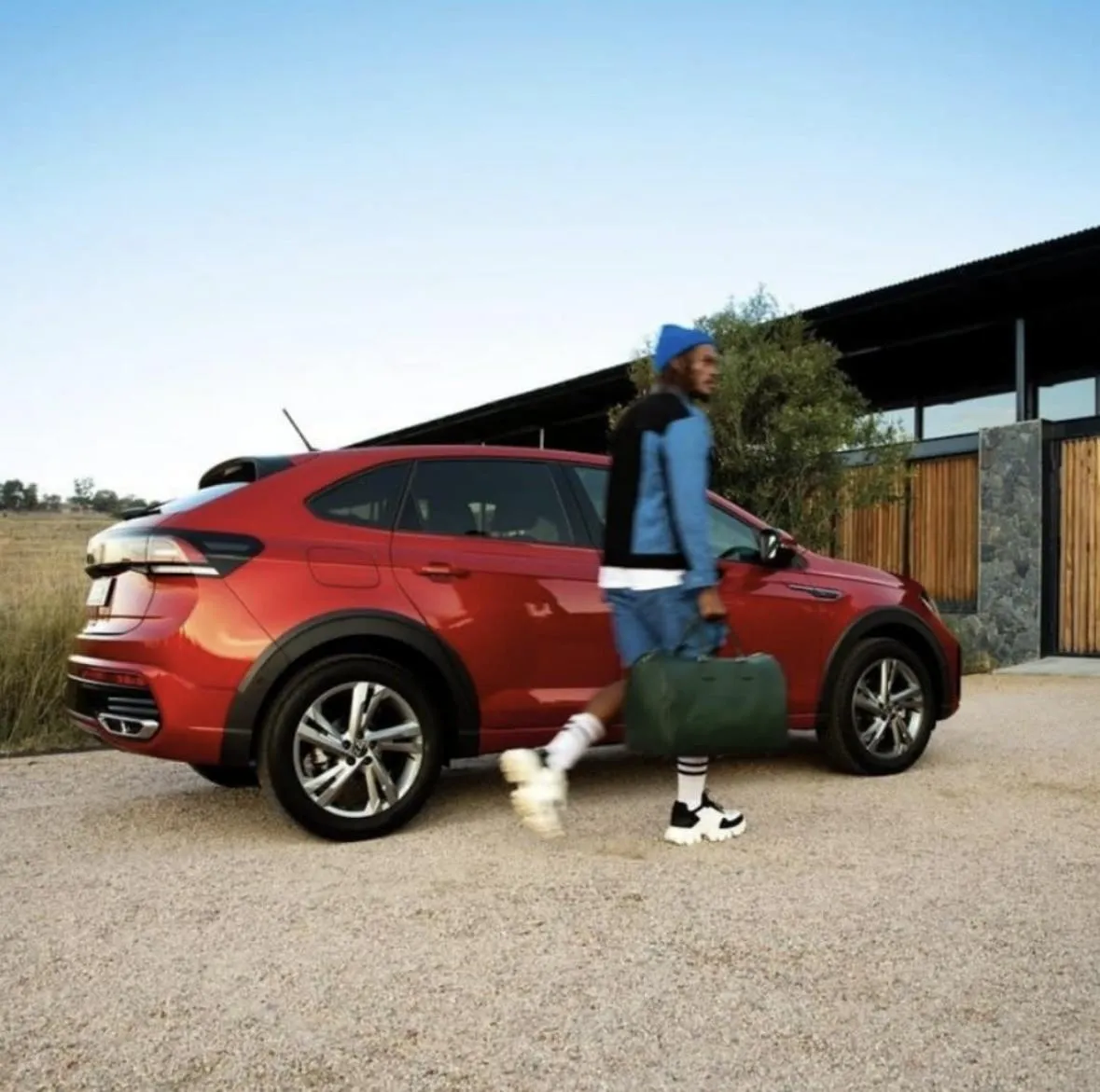 Studio commercial frame of Thabang with high-end lifestyle prop on minimal set with directional key light.