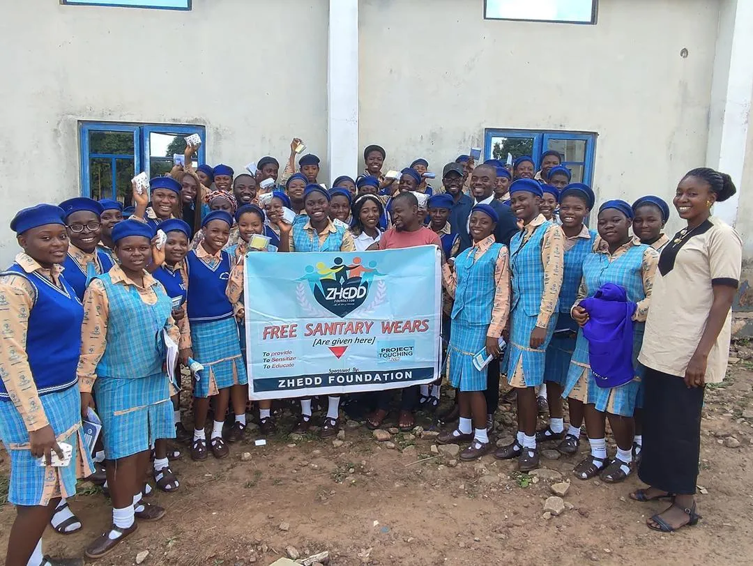 person holding orange flower petals
