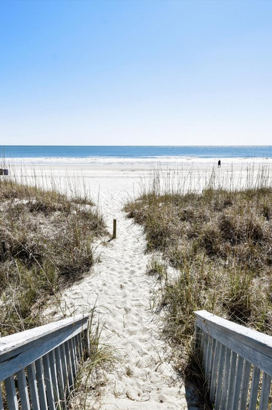 woman setting sheets on bed