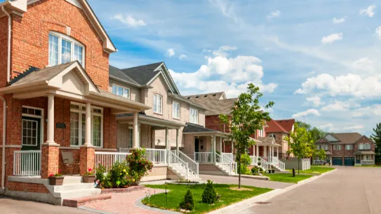 a modern house with a pool and lounge chairs
