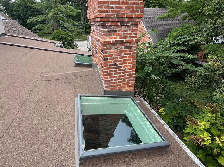 House with a flat roof and architectural shingles