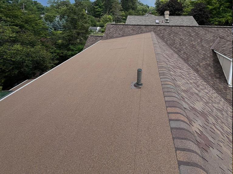 House exterior featuring a charcoal standing seam metal roof