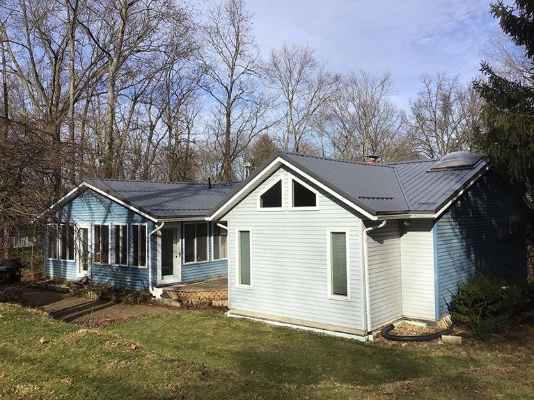 Brick ranch house with a gray metal roof