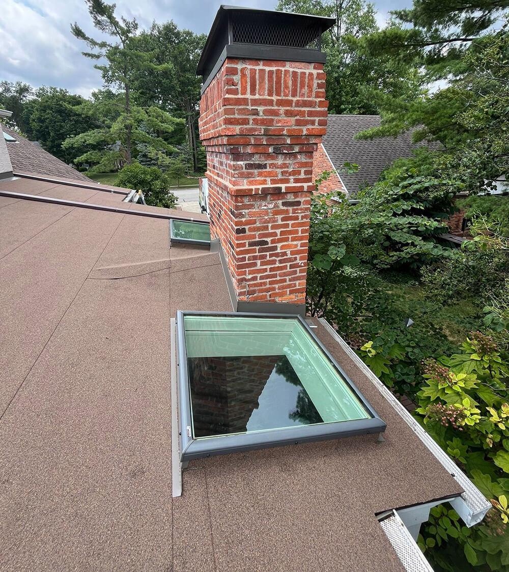 House with a flat roof and architectural shingles