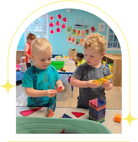 two infant boys playing with lego