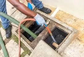Bajan plumber claning grase trap