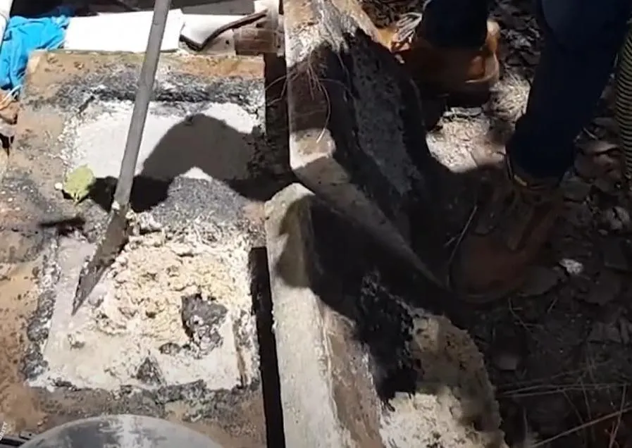 Bajan plumber claning grase trap