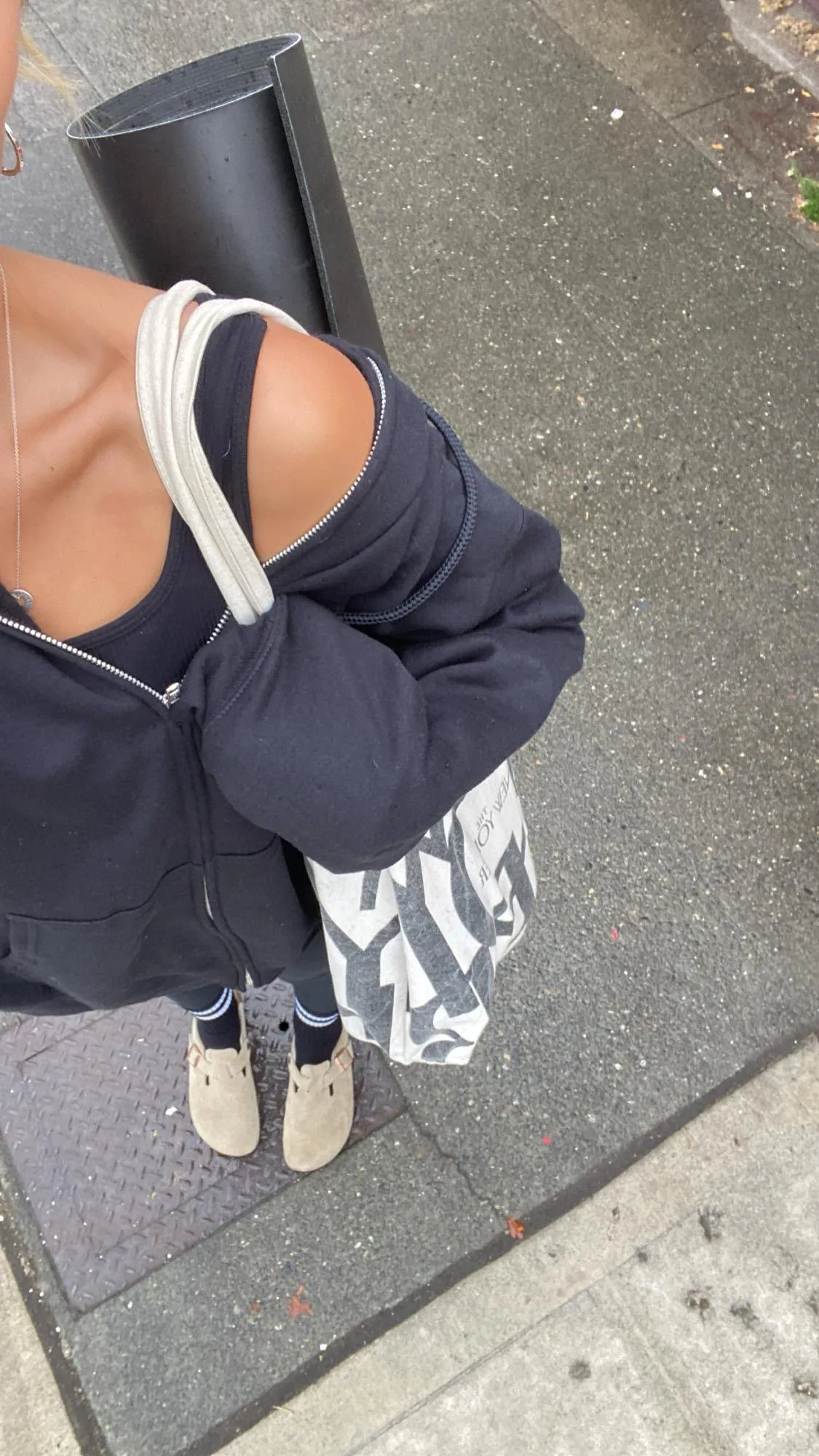 girl carrying yoga mat over her shoulder
