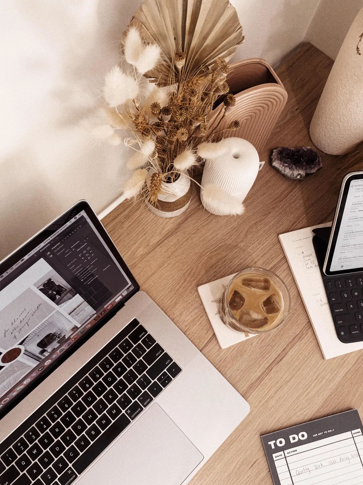 desk with a laptop, to do list, coffee and ipad