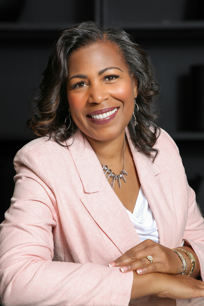 A middle-aged author with expressive eyes and a gentle smile, seated at a vintage wooden desk surrounded by handwritten notes and classic novels. Warm, golden afternoon light streams through a window, highlighting the author's thoughtful demeanor and creative workspace, evoking inspiration and literary dedication.