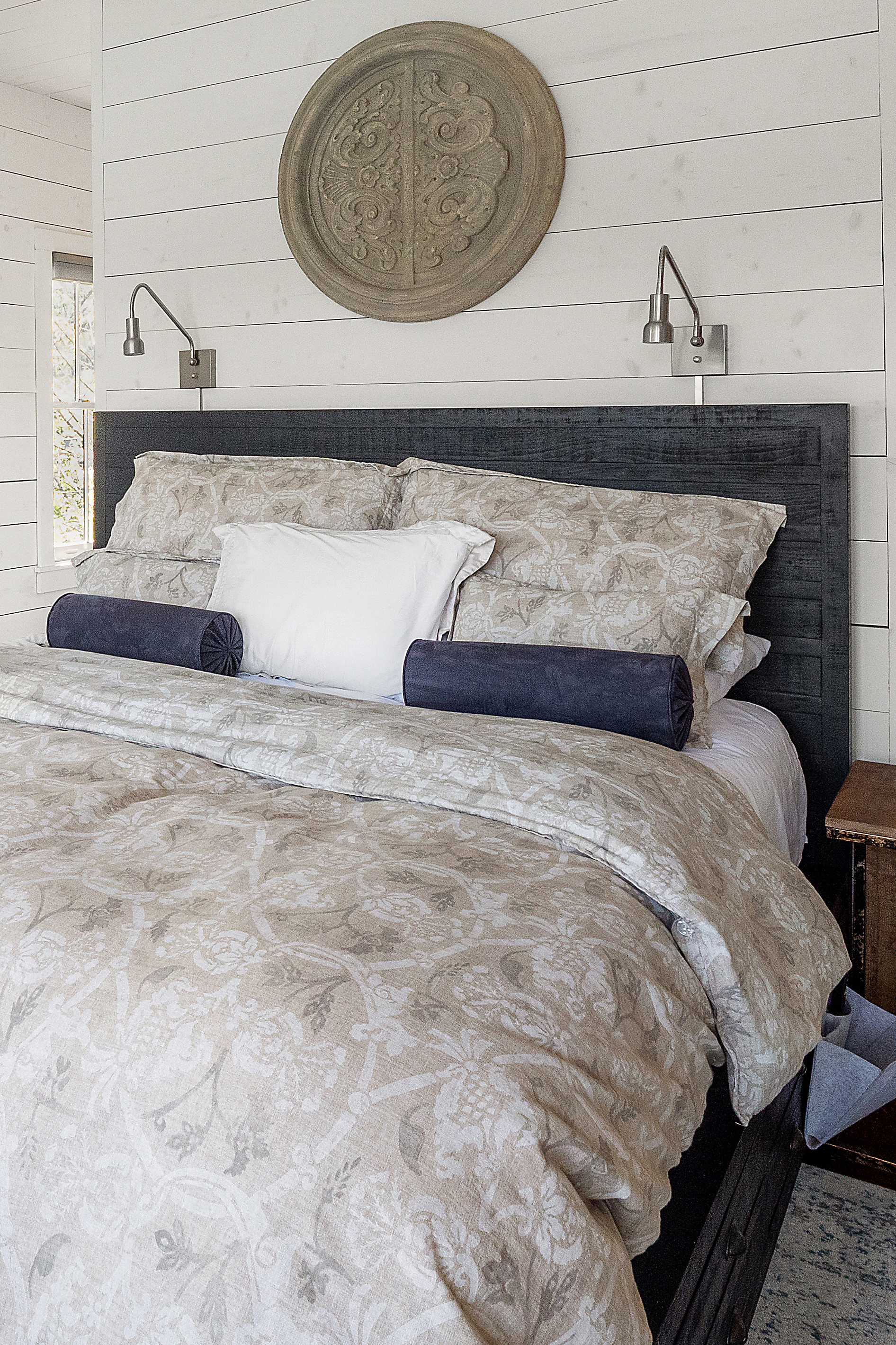 woman setting sheets on bed