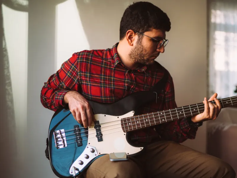 Adult male enjoying learning Bass Music Lessons at Lochwood Academy
